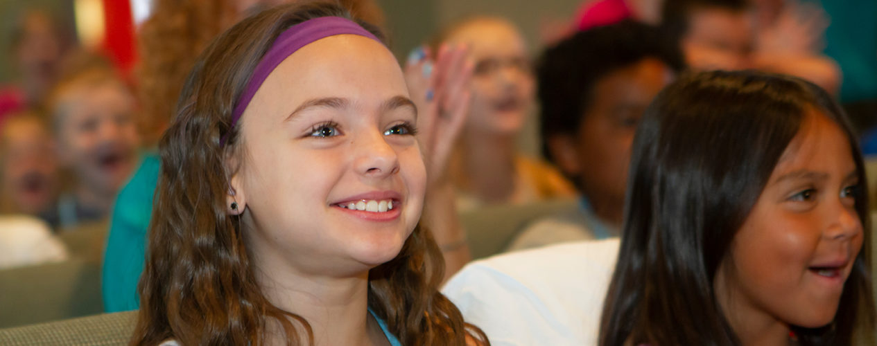 A preteen smiling during a lesson on missions.