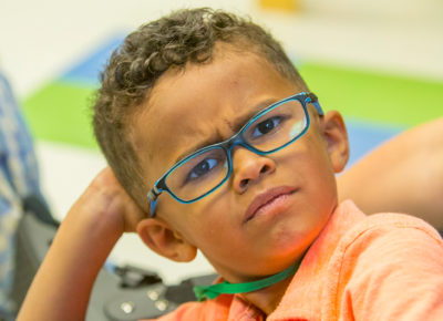 An elementary aged boy stares with a confused look on his face.