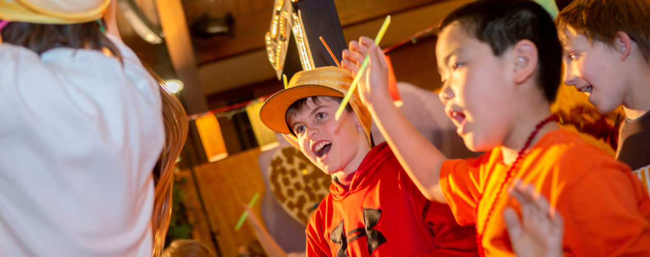 Kids will fun hats, glow sticks, ad bright camp shirts and smiling, laughing and yelling joyful praises!