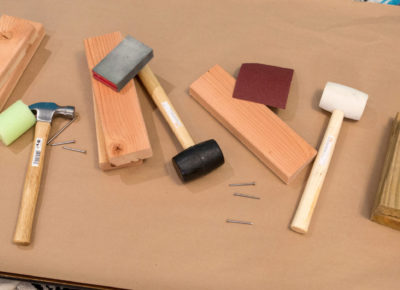 A father's day event table that has a variety of construction tools on top of a piece of cardboard.