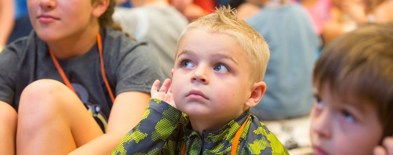 A preschool boy listens during a lesson on marking good choices.