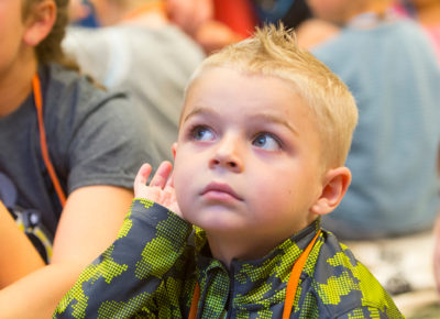 A preschool boy listens during a lesson on marking good choices.
