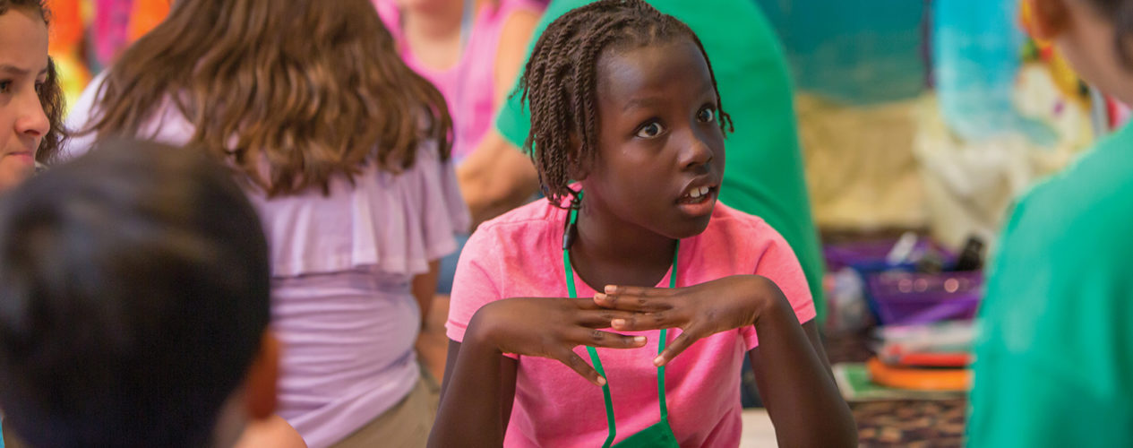 A elementary girl looks shocked during a lesson about the woman at the well.