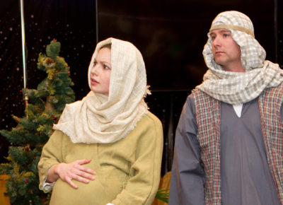 Two adults dressed as Mary and Joseph for a Christmas program.