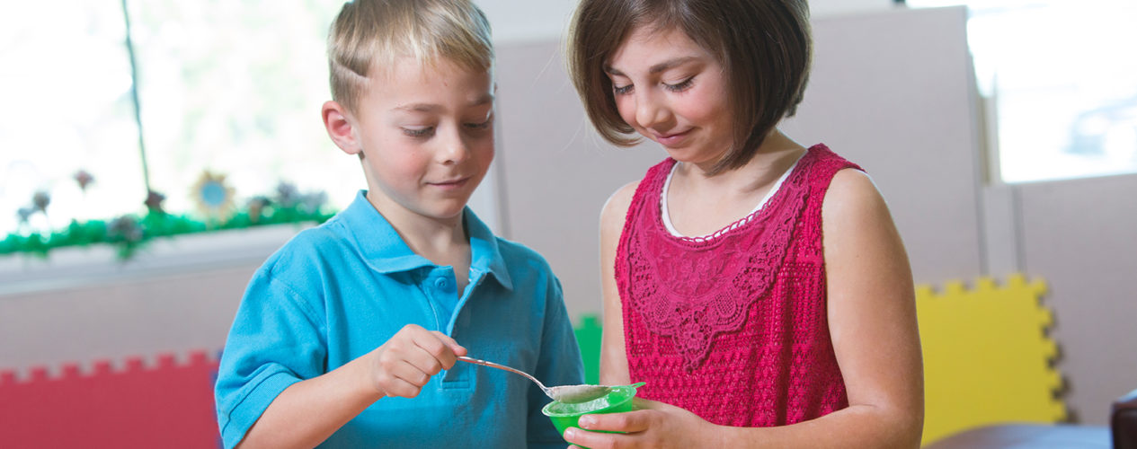 Two kids doing a science experiment.