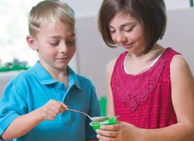 Two kids doing a science experiment.