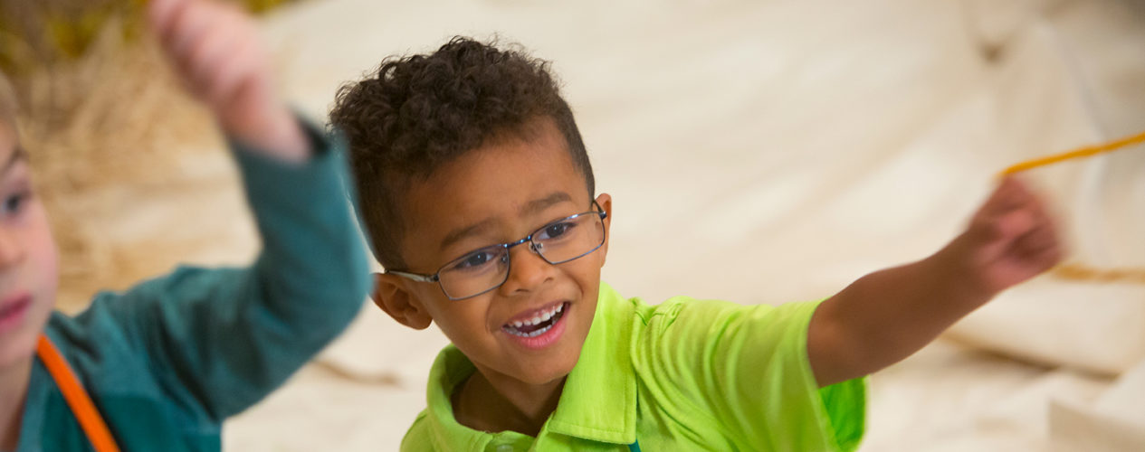 A preschool boy smiles during a David and Goliath lesson.