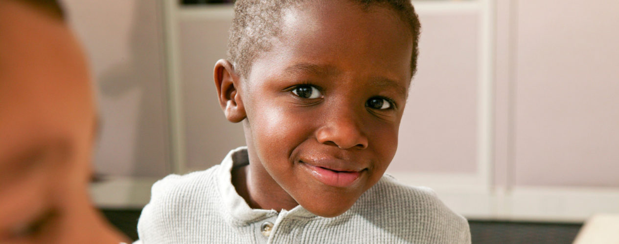 Elementary aged boy looks at the camera with an inquisitive look.