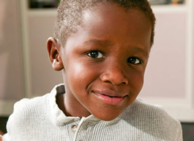 Elementary aged boy looks at the camera with an inquisitive look.