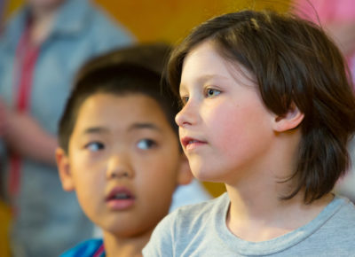 An elementary girl has a serious expression during a lesson on grief.