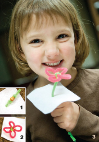 Little girl holding her "Faith Like a Seed" craft. In one corner there is a insert that shows the wooden bead wrapped in a green chenille wire. The other part of the corner shows the flowers made of chenille wire.