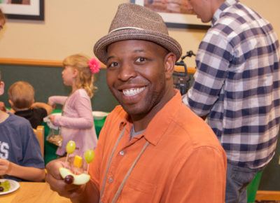 A parent smiles as he participates at a special event.