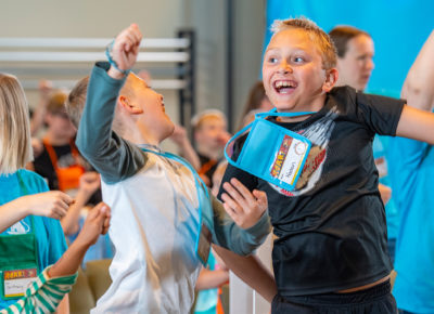 A group of children jumping up while playing the floor is lava.