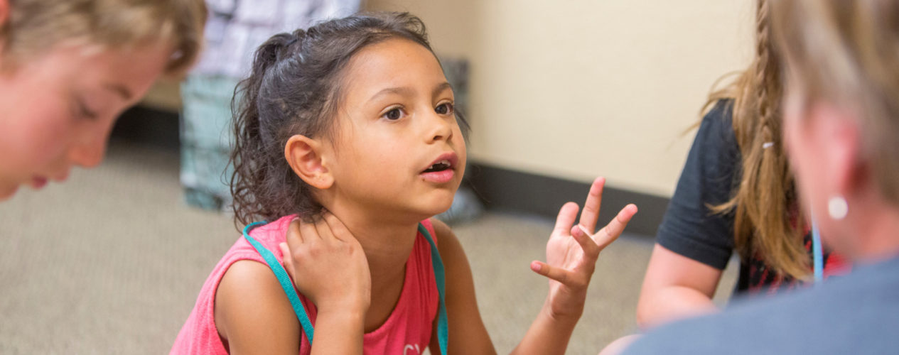 A little girl asks a question during a lesson on Cain and Abel.