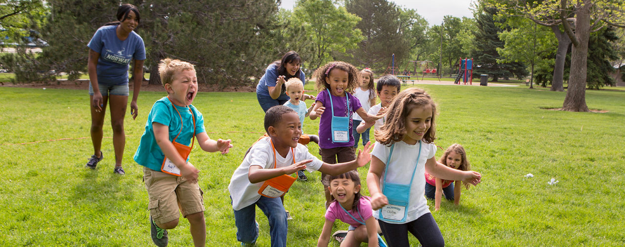 A group of children play a high-energy game outside to calm down.