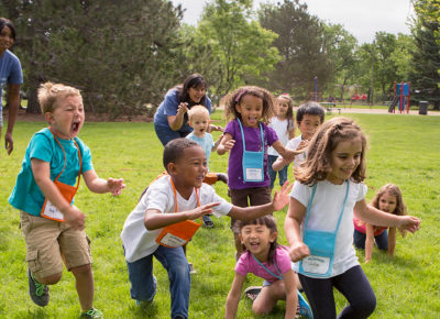 A group of children play a high-energy game outside to calm down.