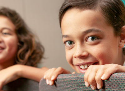 Two elementary children play a game of cooperative musical chairs.
