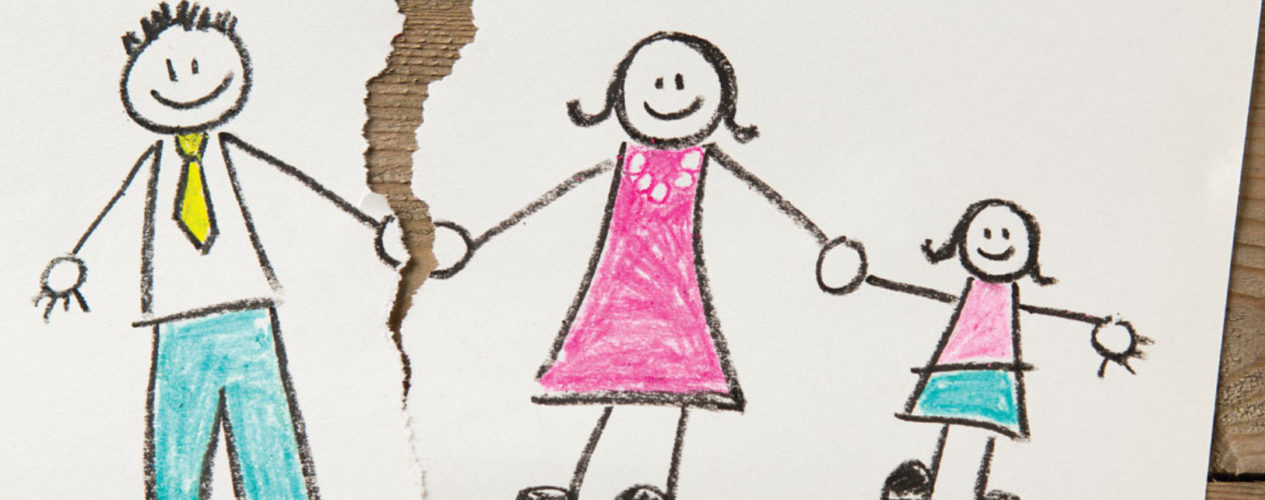 A kid's drawing of a stick figure mom, dad, and daughter, holding hands. The paper is torn between the mom and dad.