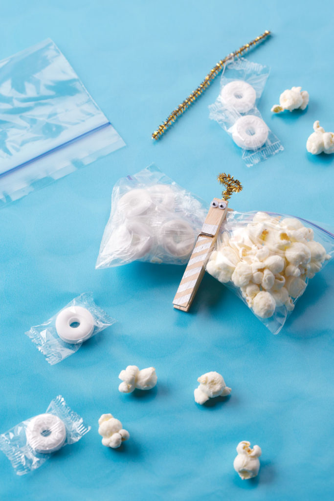An angel made out of a clothespin and a ziploc bag fulled with popcorn and mints.