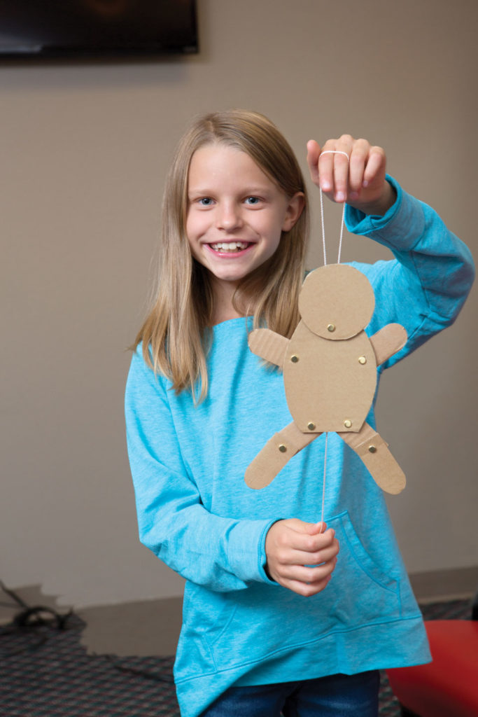 Preteen girl with a dancing baby craft.