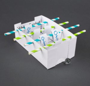 A paper foosball table with straws.