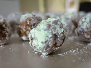 An oatmeal no bake cookie rolled in a green powdered sugar.