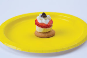 An image of the vanilla wafer banana snack from the Love-Based preschool activities list. It is sitting on a yellow plate.