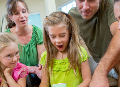 family excited about what girl in yellow is doing