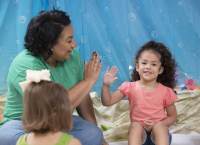 senior pastor connecting with children