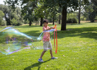 boy holding giant bubble wand