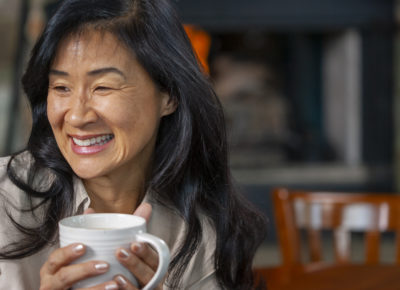 volunteer holding coffee mug and smiling