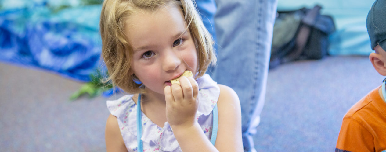 preschooler eating snack and learning how Jesus feeds people