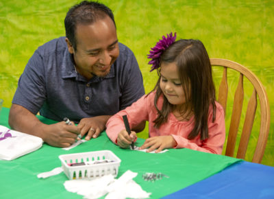father and daughter making craft for father's day outreach