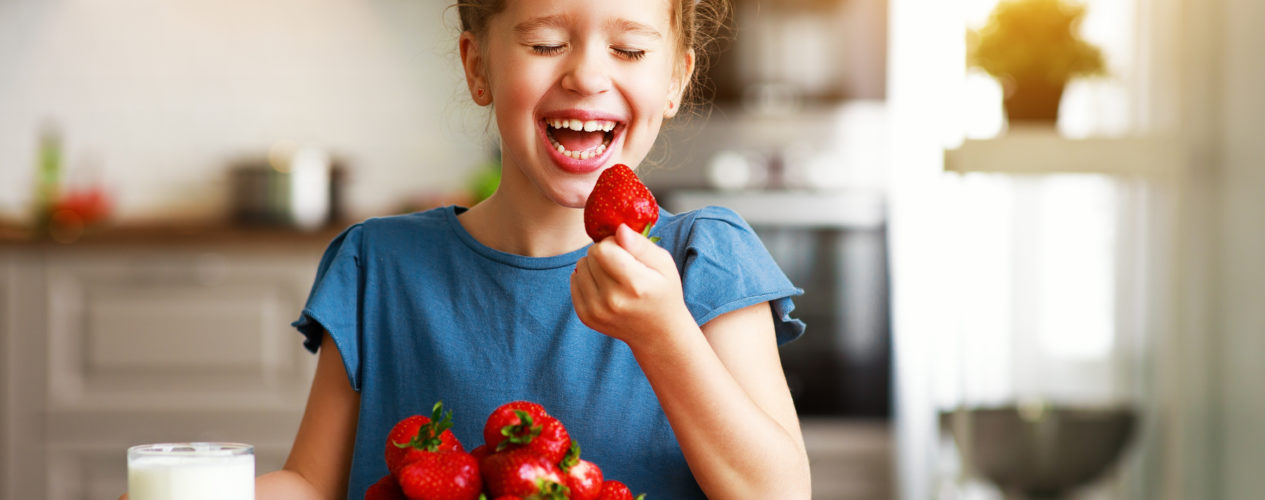 girl eating strawberries as an Independence Day snack