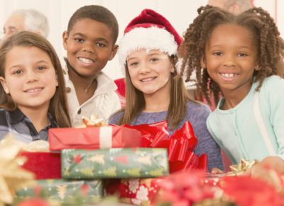 kids smiling and holding presents