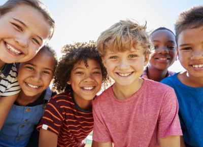 group of multiracial kids all smiling