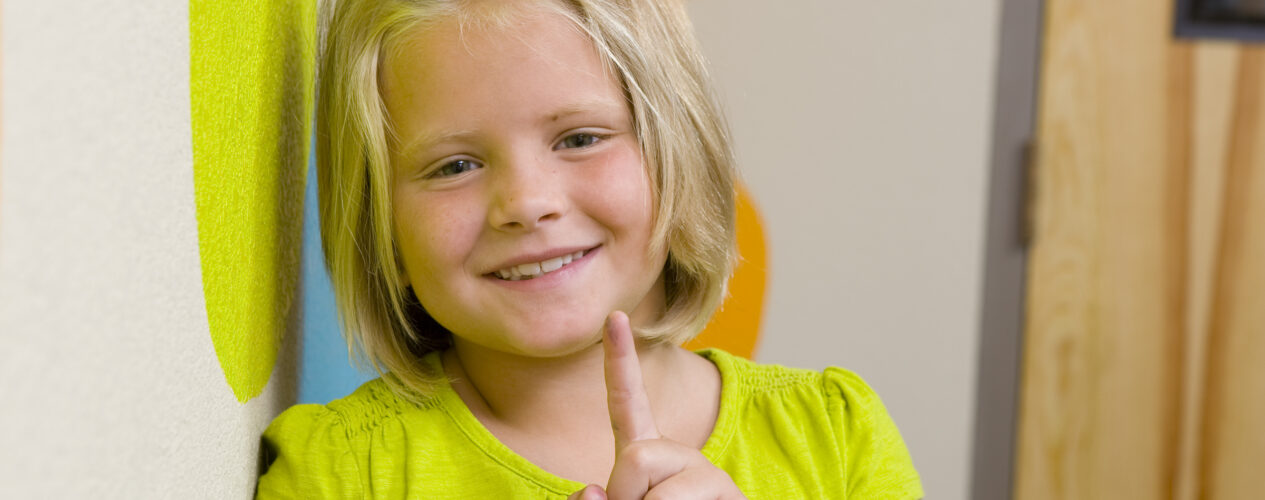 girl with finger pointing up for one point learning
