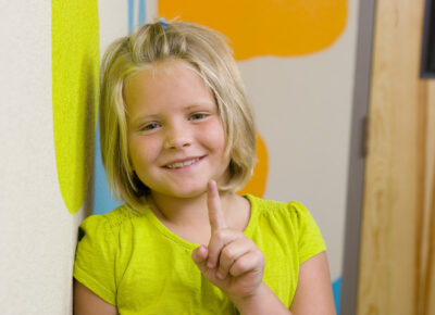 girl with finger pointing up for one point learning