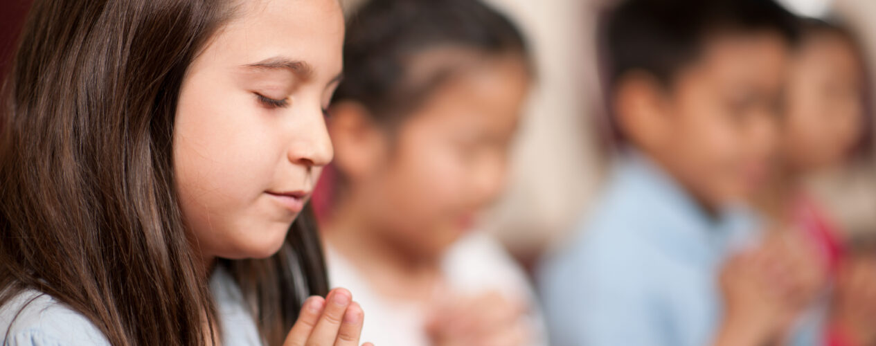 Kids praying with each other