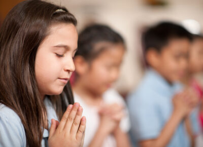 Kids praying with each other