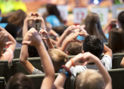 kids making heart hands to show love
