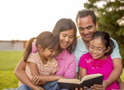 a young family reading the Easter story