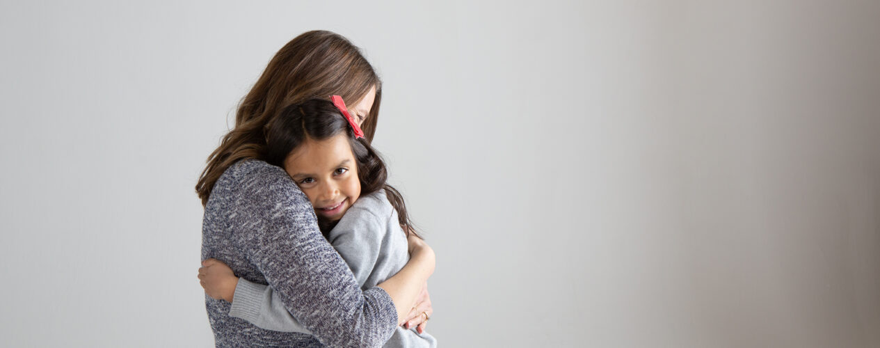 girl hugging parent as their family navigates divorce