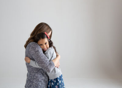 girl hugging parent as their family navigates divorce