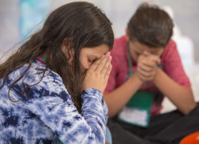 kids praying during Bible lesson