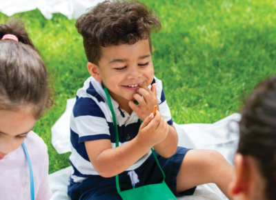 child eating summer snack outside