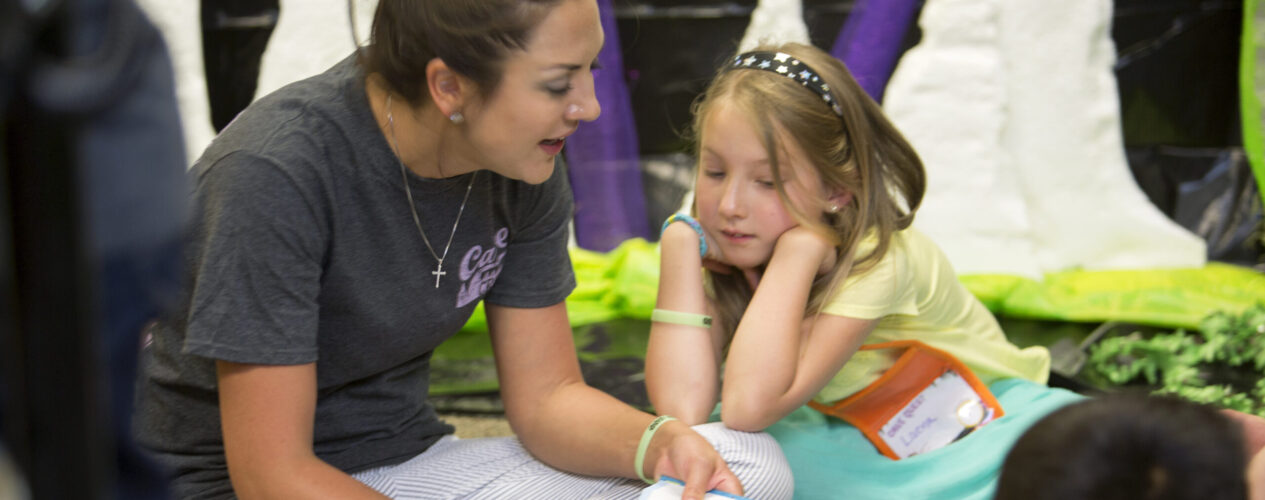 Teacher helping child with Bible memory