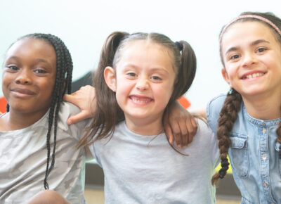 Girls smiling after playing a game that reminds kids to give thanks