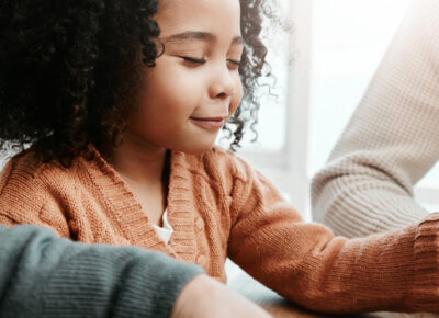 A young girl prayers with her family.