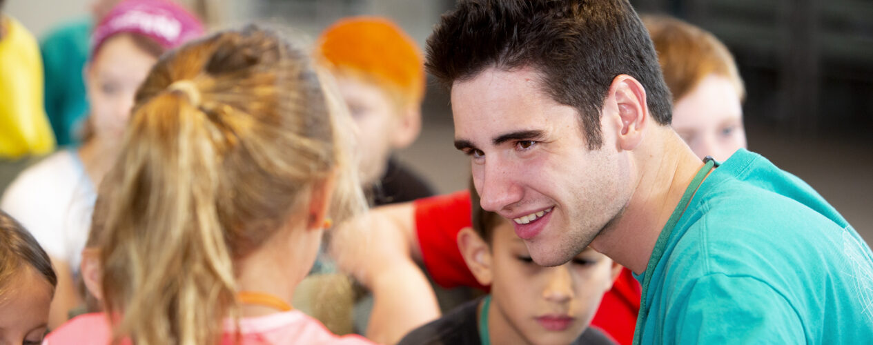 Kidmin leader talking with children about disabilities.